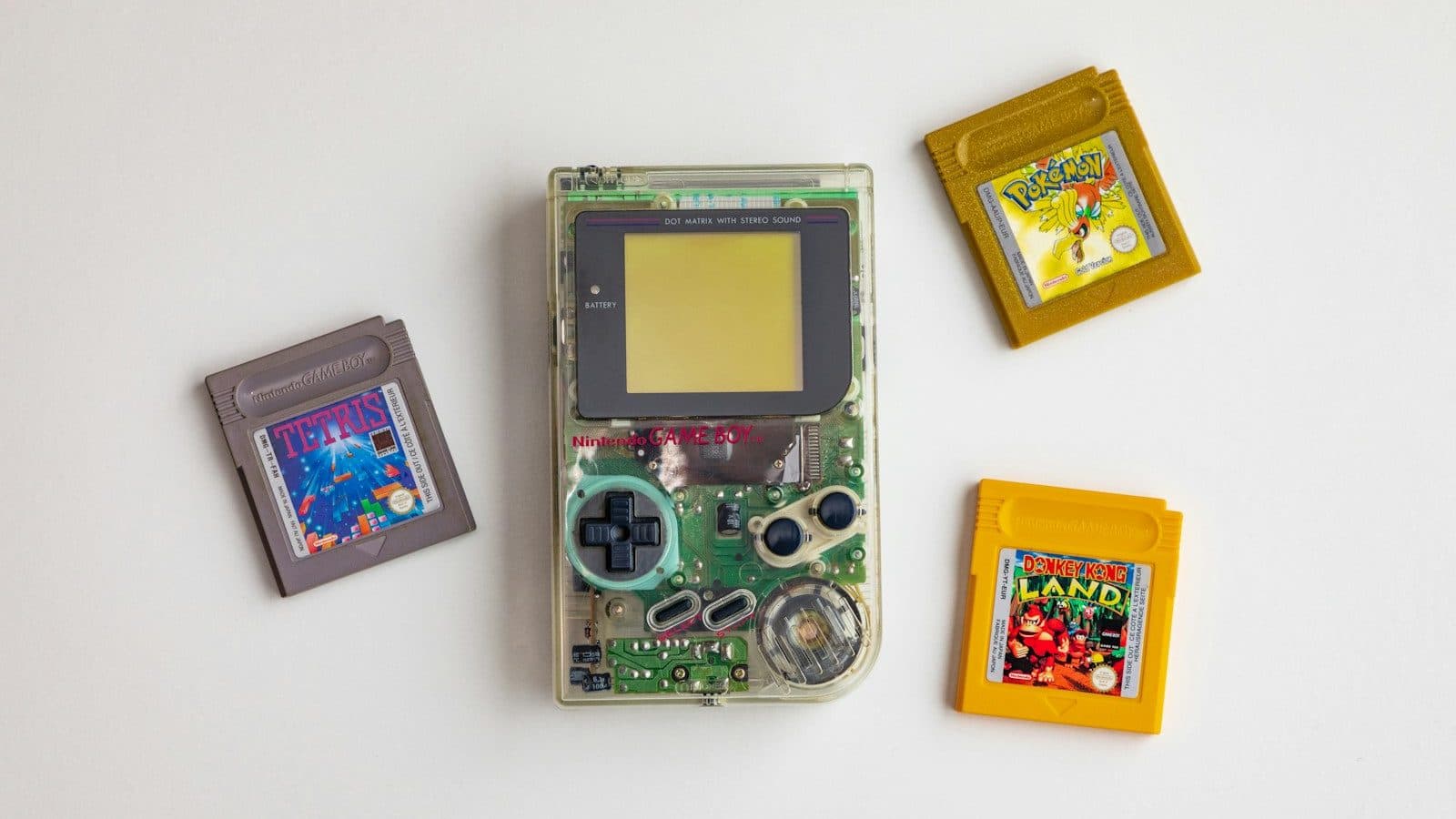 clear and green Nintendo GameBoy on white surface